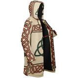 A hooded longline cardigan featuring a cream base with red Celtic knot patterns and a green triquetra symbol, shown on a plain white background.