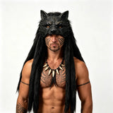 Man wearing a black wolf mask and wig with tribal tattoos on a white background