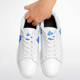 A pair of white low-top sneakers with blue geometric logo accents on the sides and tongue, shown against a light gray background with a hand holding the collar of one shoe.