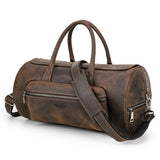 Brown leather duffel bag with shoulder strap on a white background