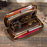 Brown leather wallet with compartments on a wooden surface