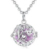Silver necklace with a round pendant featuring a purple heart design on a white background