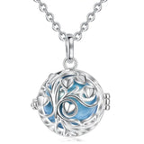 Silver tree of life pendant with blue interior on a white background