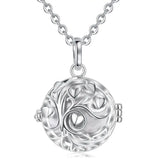 Silver necklace with a round, intricate pendant on a white background