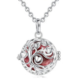 Silver necklace with a round pendant featuring a tree design on a white background