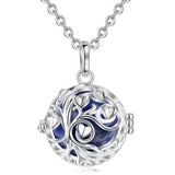 Silver necklace with a round pendant featuring a blue design on a white background