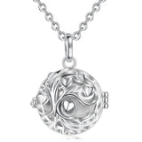 Silver circular pendant necklace with intricate design on a white background