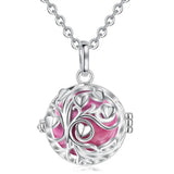 Silver necklace with a pink tree of life pendant on a white background
