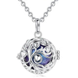 Silver necklace with a round pendant featuring a tree of life design on a white background