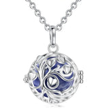 Silver necklace with a round pendant featuring a tree design on a white background