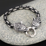 Bracelet with wolf head design on a stone surface