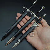 Three ornate medieval swords held in a hand 