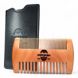 Wooden comb with black leather case on a white background