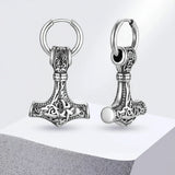 Silver Thor's hammer keychains on a light gray background 