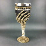 Wine goblet with skeleton hand design on a white background