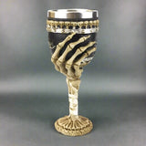 Wine goblet with skeleton hand design on a white background