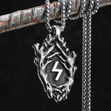 Silver pendant with a Rune symbol on a chain against a dark background