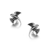 Pair of silver bat-shaped earrings on a white background