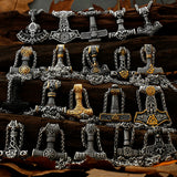 Collection of silver and gold Thor's hammer pendants on a wooden surface.