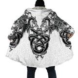 Person wearing a white coat with black intricate Norse dragon designs on the back