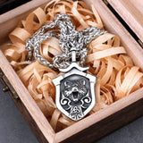 Silver necklace with a bear pendant in a wooden box with shredded paper