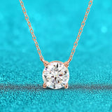 Rose gold necklace with a diamond pendant on a turquoise background