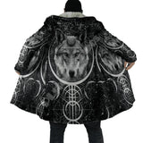 Person wearing a black and white cape with wolf designs and symbols.