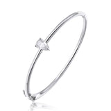 Silver bracelet with a clear gemstone on a white background
