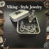 Viking-style jewelry set with necklace and pendant in a tin box, surrounded by decorative elements.