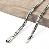 Silver braided cable on a wooden surface