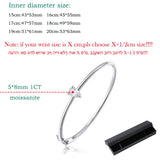 Silver bracelet with moissanite gemstone and size chart on a white background