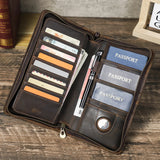 Brown leather wallet with card slots and passport holder on a wooden surface