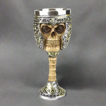 Skull-shaped goblet with intricate designs on a white background