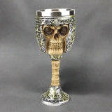 Skull-shaped goblet with intricate designs on a white background