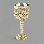 Decorative goblet with skull design on a white background