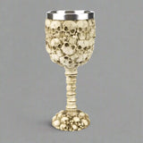 Decorative goblet with skull design on a white background