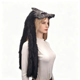 Person wearing a black fur hood with wolf ears on a white background