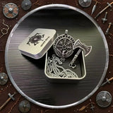 Viking-inspired jewelry set with axe design in a box, surrounded by decorative items on a wooden background.