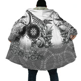 Person wearing a white jacket with intricate black designs on a white background