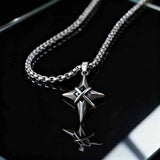 Silver star-shaped pendant necklace on a reflective surface