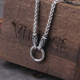 Silver chain necklace with a ring pendant on a wooden box with 'Vikings' branding.