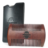 Wooden comb with black leather case on a white background
