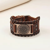 Brown leather bracelet with metal clasp and engraved design on a white background