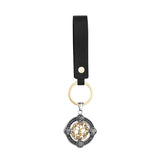 Keychain with black strap and decorative pendant on a white background