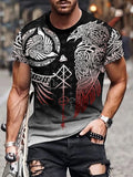 Man wearing a black and gray t-shirt with intricate designs, standing on a street.