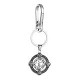 Silver keychain with intricate design on a white background