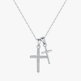 Silver cross pendant necklace on a white background 