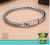 Silver bracelet on a beige background with '100% S925' and '100% Sterling Silver' labels.