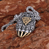 Viking-style bear claw pendant with chain on a stone surface