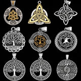 Collection of various silver and gold pendants on a black background